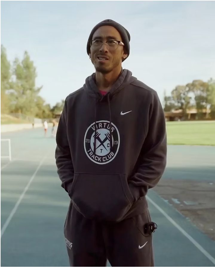 Coach Sean Gwi in Virtus Track Club kit at the track